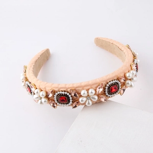 Macro detail of Baroque headband with pink rhinestones, red gems and white pearls