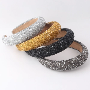 Detail of four padded headbands with sparkling rhinestones and pearls in silver and gold