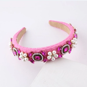 Detailed macro shot of pink baroque headband with woven fabric, pearls and pink rhinestones
