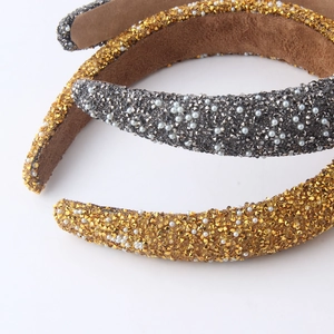 Macro detail of headband featuring shimmering rhinestones and elegant pearls