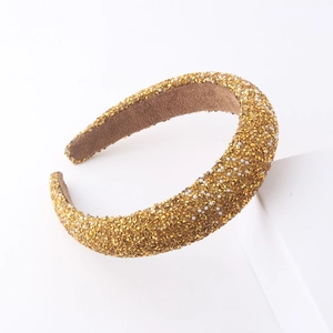Luxury gold padded headband with sparkling crystals and white pearls on white stand