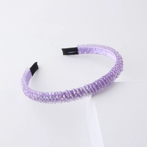 Detailed shot of purple beaded headband with crystal facets and soft black ends for comfort