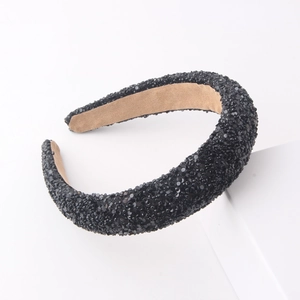 Luxe wide black headband with full rhinestones and pearls on a white geometric stand
