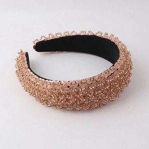 Close-up of rose gold beads and sequins on a thick black padded headband detail