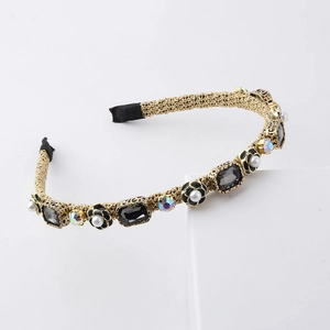 Detail view of woven headband with camellia, pearls and rhinestones on white pedestal