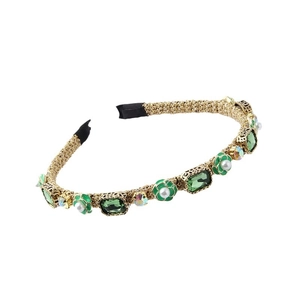 Elegant gold braided headband with green crystals, pearls and emerald flower accents
