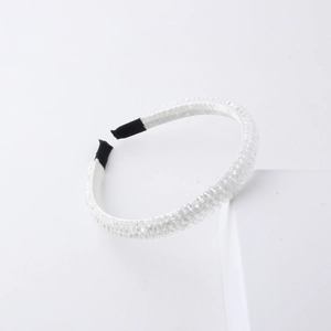 Detail of beaded headband featuring shimmering crystal beads and white fabric wrap