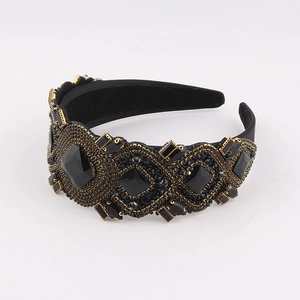 Baroque retro headband with black gemstones and golden metal edge on a white background