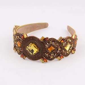 Macro shot of Baroque wide headband with amber crystals and gold beads on suede lining