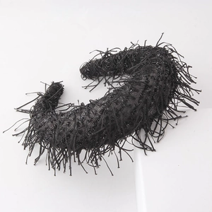 Macro shot of black mesh headband with long fringe tassels showing punk style texture