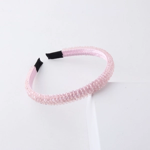 Detail of pink crystal beaded headband with satin lining and protective black tips