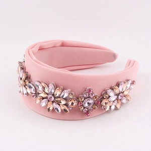 Pink padded rhinestone headband featuring sparkling crystal floral patterns on soft fabric