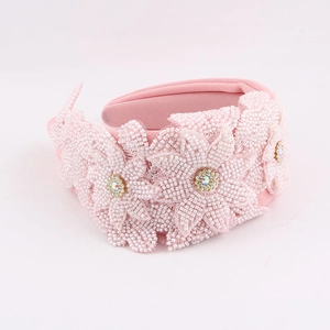 Detail of pink handmade beaded flower headband with sparkling colorful rhinestones