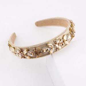 Macro shot of Baroque wide headband with champagne crystals and pearls on white podium