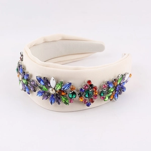 Macro detail of beige fabric headband featuring colorful rhinestones in floral patterns