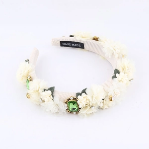Baroque padded headband with white fabric flowers, pearls, and a green gemstone