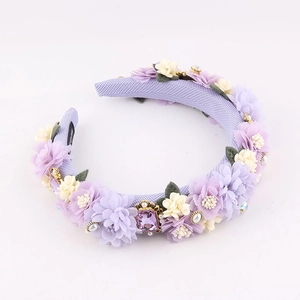 Detail view of purple baroque sponge headband with lace flowers, pearls and rhinestones