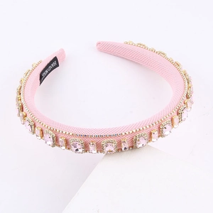 Detailed macro view of pink crystal rhinestones on a handmade padded fabric headband
