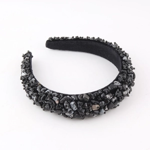 Detail of handmade padded headband with black velvet fabric and shimmering crystal beads