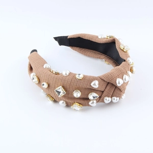Bohemian knotted wide headband with white pearls and sparkling rhinestones on brown fabric