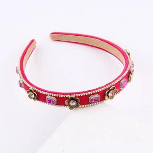 Close-up of hot pink velvet headband with gold flowers and pink rhinestones