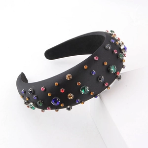 Detail of sponge padded headband with colorful rhinestones on black satin fabric