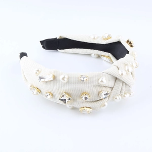 Elegant wide knotted headband with faux pearls and rhinestones on cream textured fabric