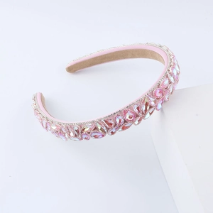 Fashionable pink sponge headband with colorful rhinestones on a white display stand