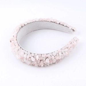 Macro detail of a pink quartz stone headband showing sparkling crushed crystal textures