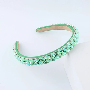 Detail of green sponge headband with emerald rhinestones and non-slip velvet inner lining