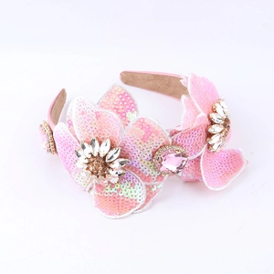 Close-up of pink sequin floral headband with crystals and gold base details