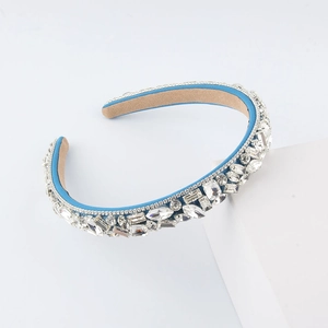 Detail view of lake blue fabric headband with emerald-cut crystals and rhinestone trim