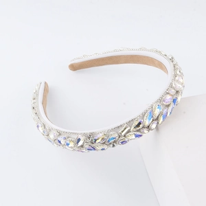 Close-up of sparkling marquee crystal rhinestones on a white sponge headband hairband