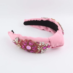 Pink knotted fabric headband with elegant rhinestones, crystals, and micro pearls