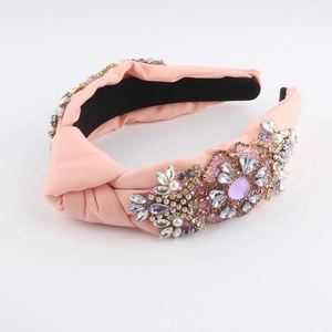 Detail of pink padded knotted headband with hand-sewn jewels, pearls and rhinestones