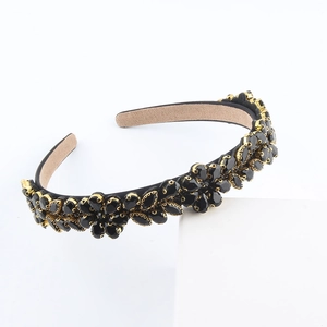 Baroque black crystal headband with gold settings and waterdrop gems on white background