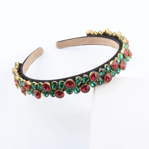 Detail of vintage gold headband with red and green rhinestones and non-slip inner lining
