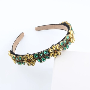 Detail of baroque headband with yellow and green floral crystal rhinestones on black band