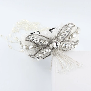 Detailed close-up of Baroque pearl butterfly hairpiece with rhinestones and beaded tassels