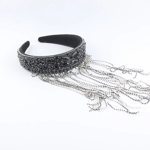 Close-up of luxury black headband featuring marquise rhinestones and silver tassels