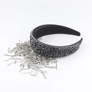 Close-up of black baroque headband featuring luxury rhinestones and silver metal fringe
