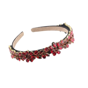 Baroque floral headband with red teardrop crystals and gold base on white background