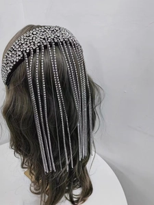 Detailed side view of luxury baroque headband with long sparkling rhinestone tassel chains