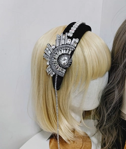 Detailed view of luxury black velvet headband with sparkling rhinestones and long fringe