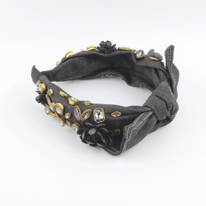 Detail of dark denim knotted headband with handmade floral accents and crystal studs
