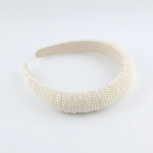 Elegant white braided sponge headband with uniform faux pearls and beige velvet lining