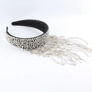Detailed macro view of luxury baroque headband with sparkling rhinestone tassels and crystals