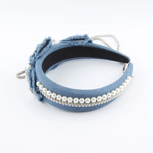 Detail of blue denim headband with white pearls, rhinestones and fringe tassels