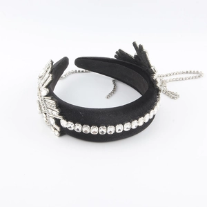 Detail view of black velvet padded headband with crystal rhinestones and long tassel chains