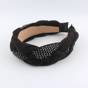 Detail of woven black fabric headband featuring sparkling rhinestones and a suede inner lining